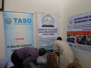 CFYDDI Programs Director Enoch being helped to put up the organisation  banner during the Consultations.